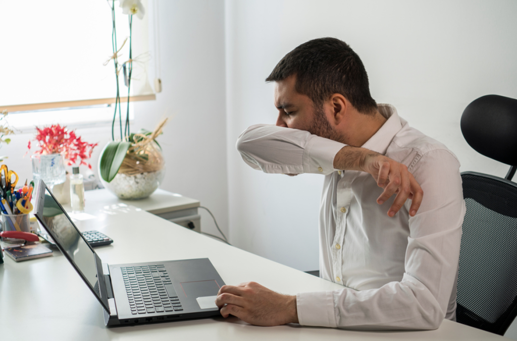 Cleaning agency in west sussex | man sneezing in arm