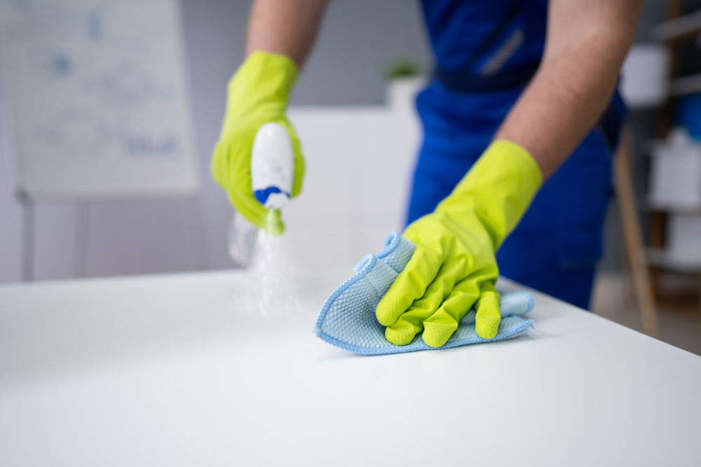 business and office cleaning services | person cleaning a desk