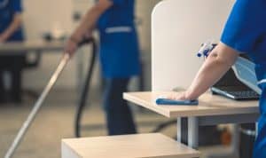 woman cleaning an office desk