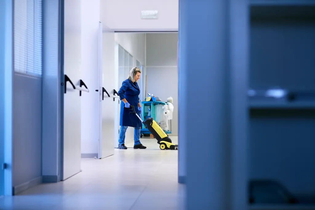 carter & faraday staff member cleaning dentist-hallway