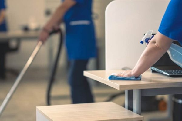 woman cleaning an office desk