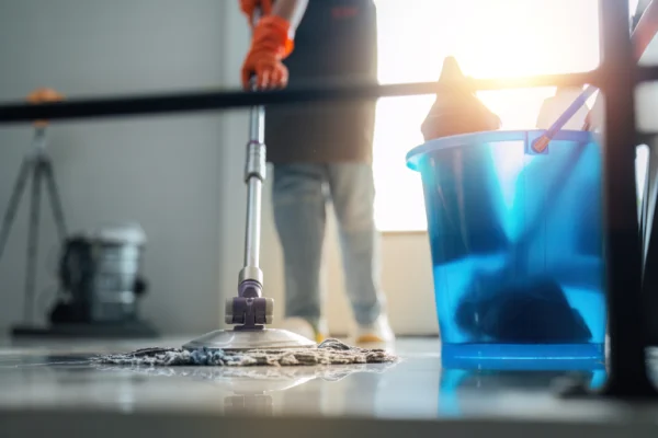 person-mopping-floor-with-blue-bucket