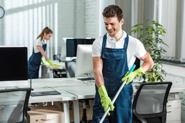 man and woman cleaning an office