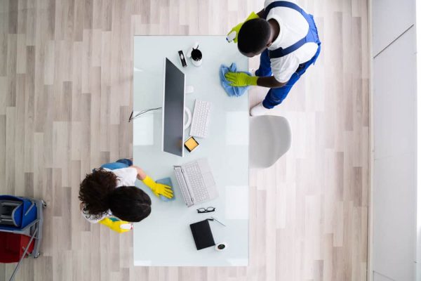 cleaners cleaning a desk
