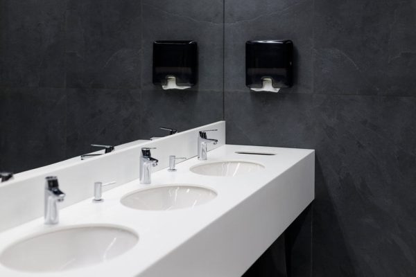 Washroom Hygiene Services sleek modern looking sinks in a work bathroom